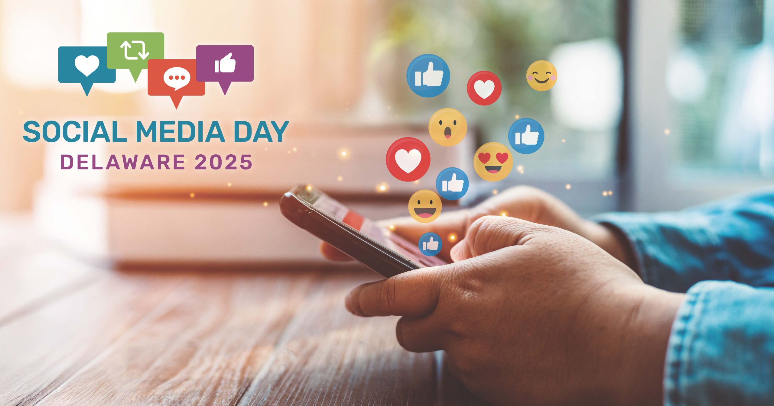 A person's hands hold a smartphone, with various social media reaction emojis like hearts, thumbs-up, and smiling faces floating above.